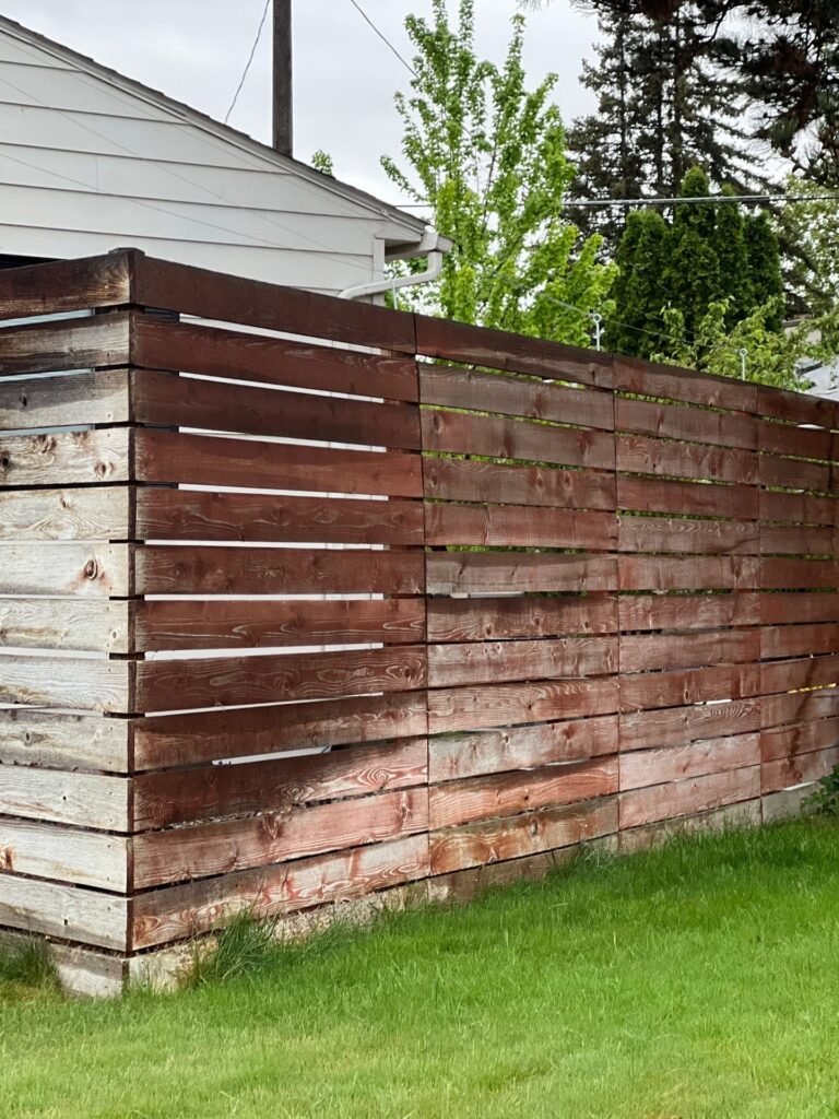 Horizontal cedar fence in Richland with faded, weathered oil stain