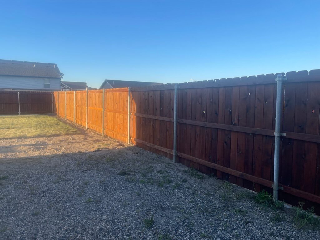 Same Pasco fence after restoration, stained in Pecan