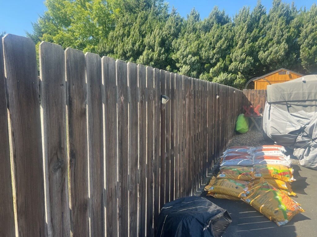 Grey weathered cedar fence in Pasco before restoration